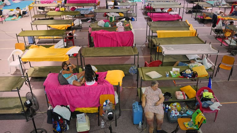 Residents rest at a sports center after being evacuated from their homes because of the threat of a wildfire in Villamanta, Madrid province, Spain.