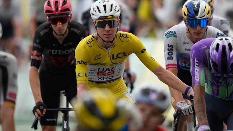 Slovenia's Tadej Pogacar, wearing the overall leader's yellow jersey crosses the finish line of the twelfth stage of the Tour de France.