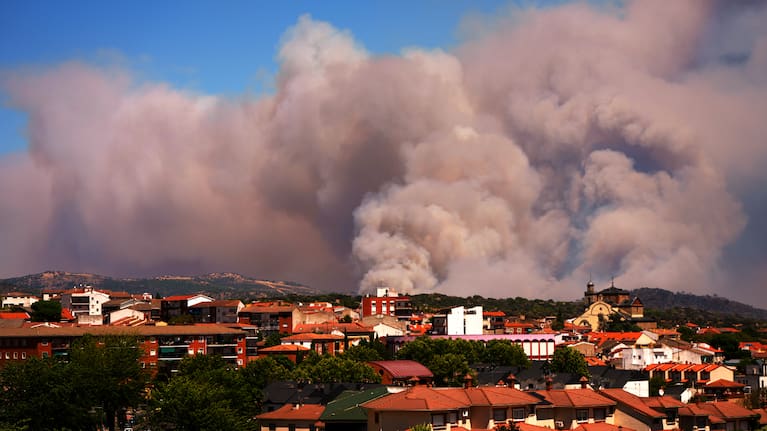 Smoke and flames rise as a wildfire advances near La Adrada, Ávila province, Spain, Friday, July 24, 2026.
