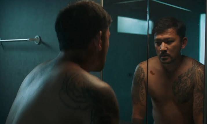 A man looking in the mirror in the movie Smothered