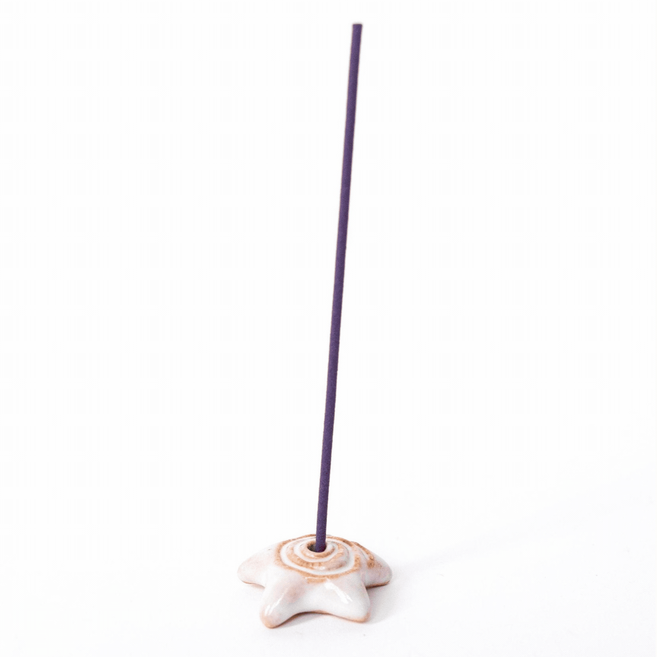 a gif of a star shaped ceramic incense holder