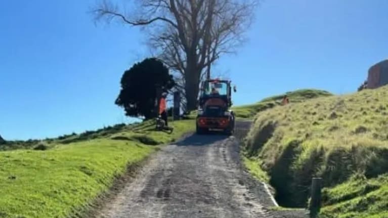 Remediation workers repair the summit track of Motukauri.