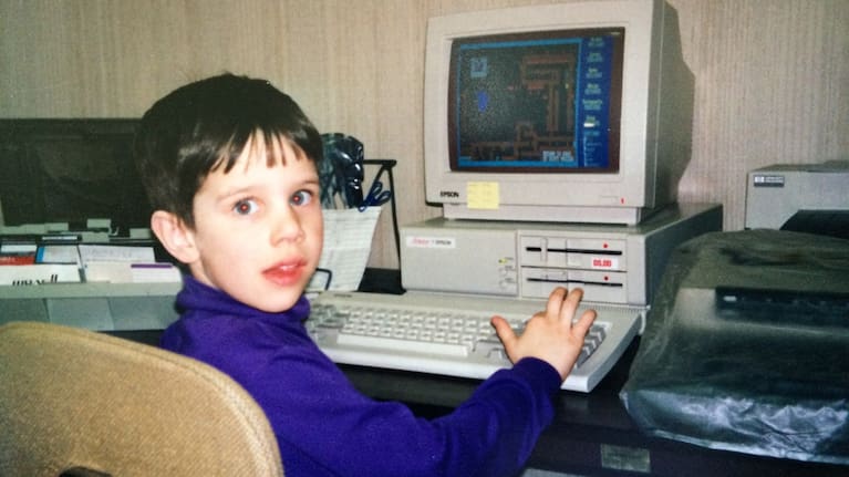 This photo provided by the family shows Kyle Bylin with a computer in the 1990s