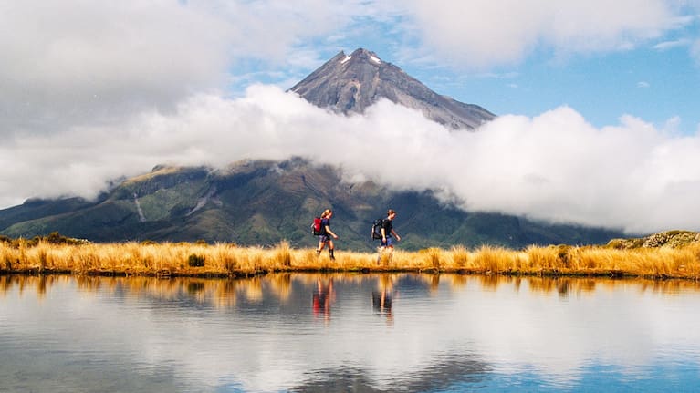 A file photo of Mount Taranaki with two hikers visible.