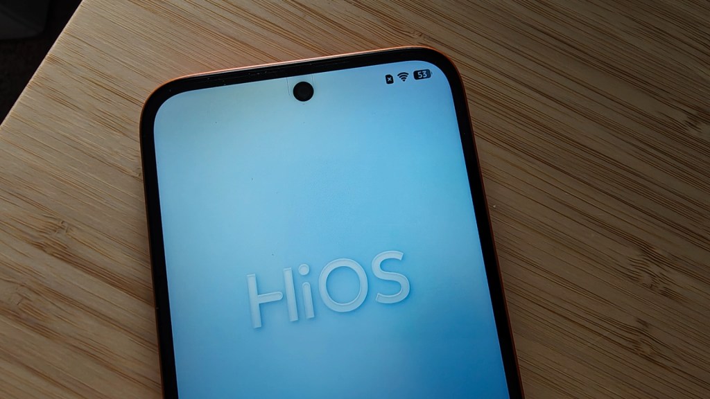 Close-up of a smartphone screen displaying the text 'HiOS' with a front camera hole and connectivity icons at the top.