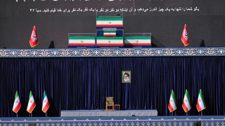 The coffins of slain Iranian Supreme Leader Ayatollah Ali Khamenei and members of his family are displayed on a platform above an empty chair at the start of the dayslong funeral ceremonies at the Imam Khomeini Mosalla Grand Mosque in Tehran, Iran.