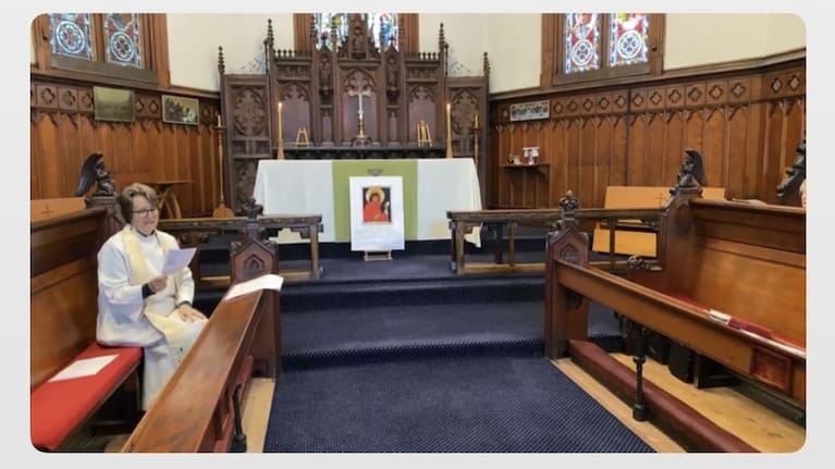 The icon's stands sit empty on the high altar as Reverend Jean Malcom holds a Eucharist. 