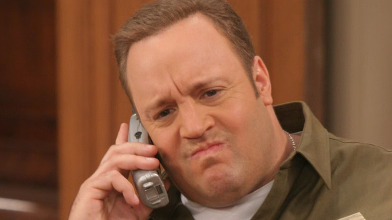 Doug taking a phone call and grimacing