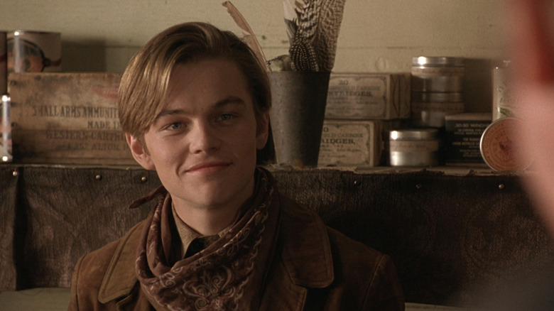 Leonardo DiCaprio's Fee "The Kid" Herod smiles as he stands in a store in The Quick and the Dead