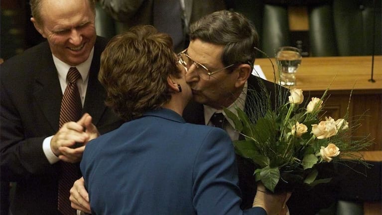 Then National Party Treasurer Bill Birch receives flowers and a kiss from Prime Minister Jenny Shipley after reading the Budget.