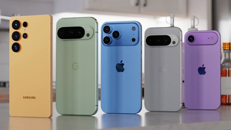 A yellow Samsung, a green Google Pixel, a blue iPhone, a grey Pixel, and a purple iPhone stand in-line on what appears to be a kitchen counter, the devices are in descending order by heighy