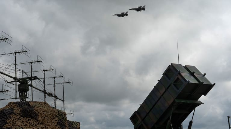 Ukrainian Air Force's F-16 fighter jets fly over a Patriot Air and Missile Defense System in an undisclosed location in Ukraine.