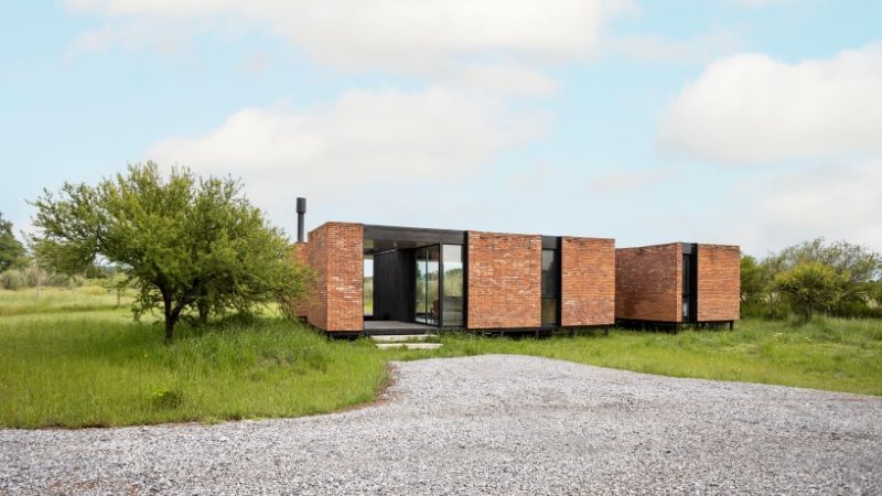 monolithic brick volumes wrap weekend house around a series of courtyards in argentina - 1