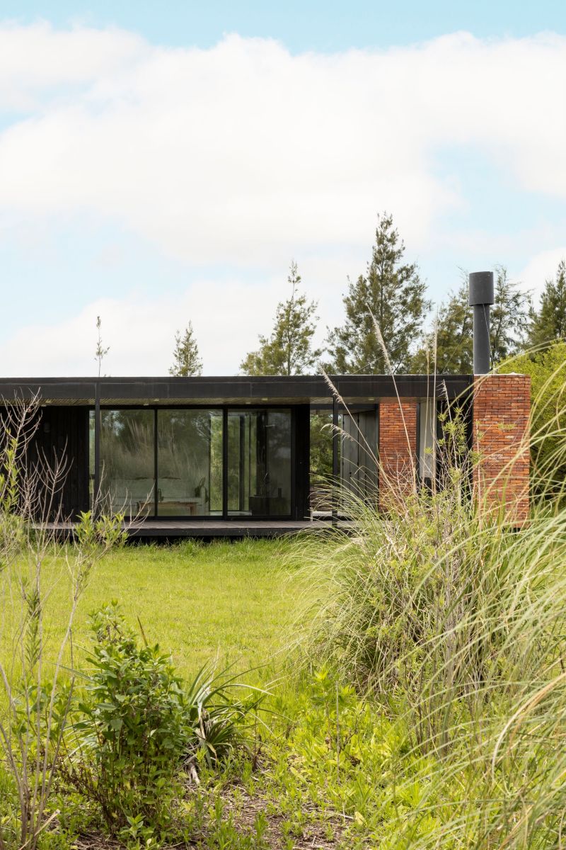 monolithic brick volumes wrap weekend house around a series of courtyards in argentina - 5