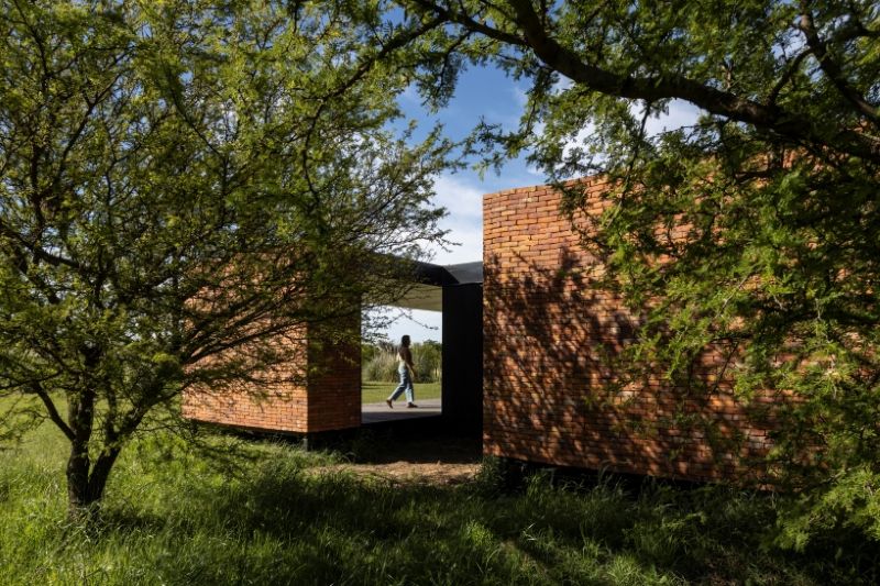 monolithic brick volumes wrap weekend house around a series of courtyards in argentina - 3