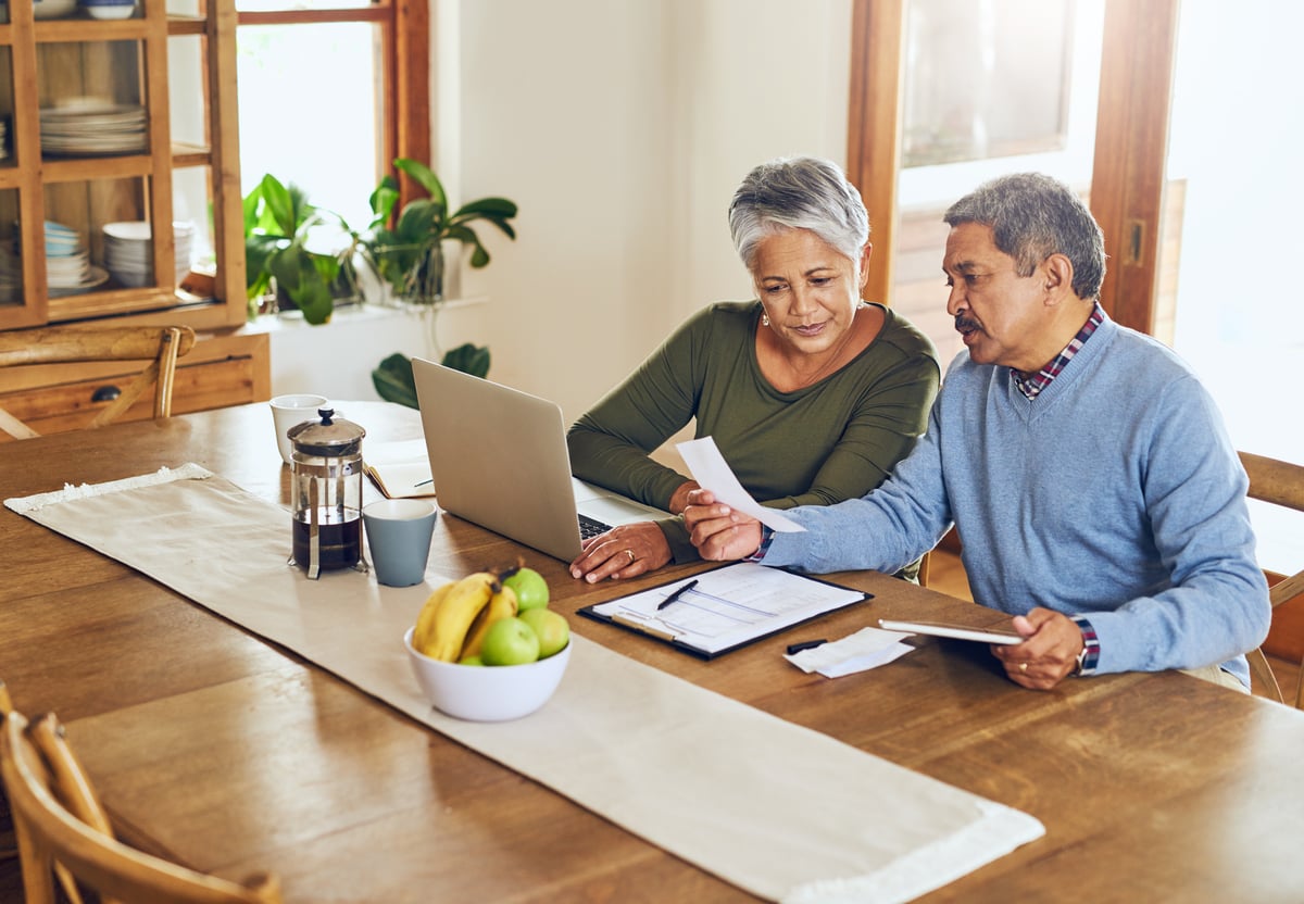 Two people sitting at table and working.