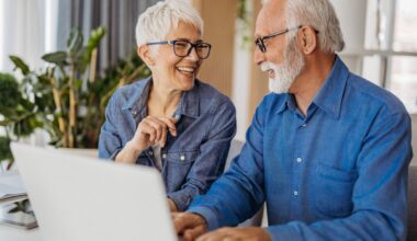 Two people at a laptop.