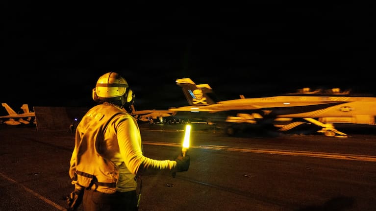 U.S. sailors conduct nighttime flight operations aboard USS George H.W. Bush (CVN 77) while transiting the Arabian Sea.
