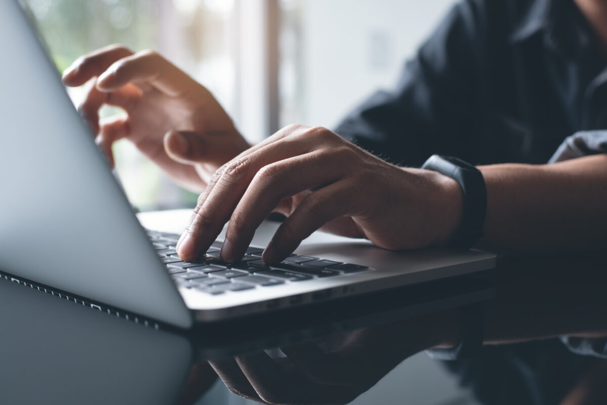 Photo shows a man's hands as he types on a laptop. A research scientist has created an AI-powered “virtual mouse” to replace traditional animal testing in nanomedicine