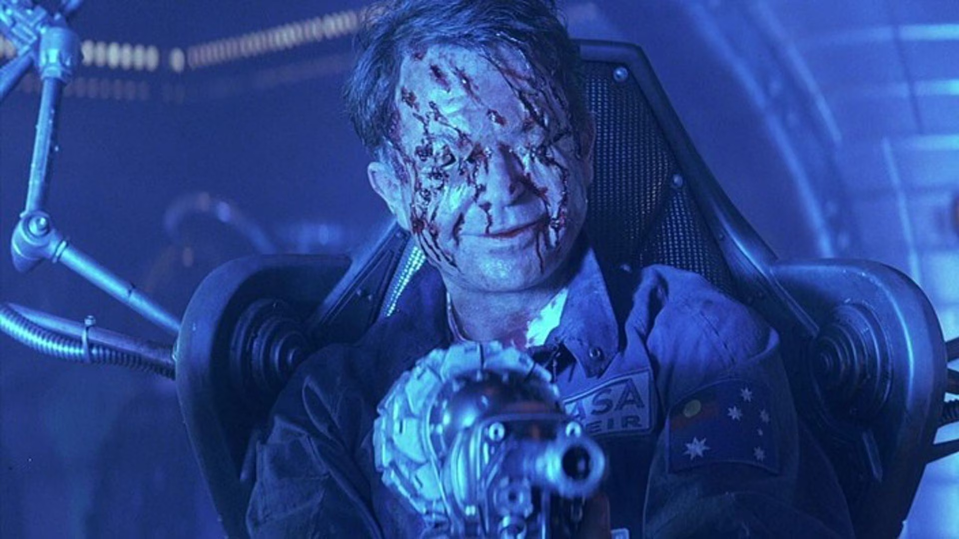 Sam Neill from the sci-fi horror movie "Event Horizon", shown possessed, with his eyes removed and blood on his face.