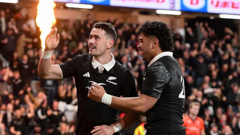Will Jordan celebrates one of his two tries against France with loose forward Wallace Sititi.
