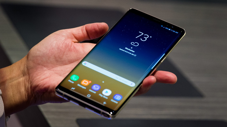 A person holding the Galaxy Note 8 phone at a press event