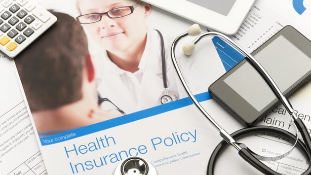 Health insurance policy brochure with paperwork. There is also a stethoscope, mobile phone and digital tablet in the image.