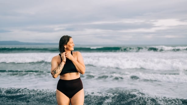 Woman expressing freedom and joy by ocean