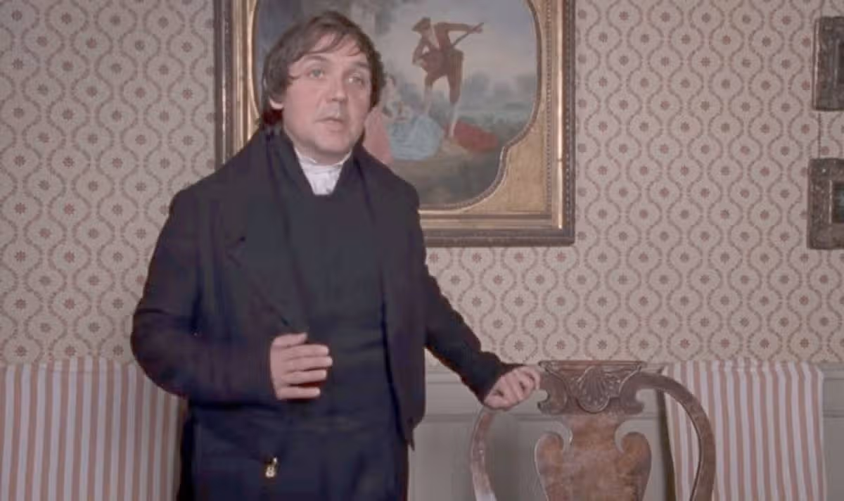 A man in black speaks