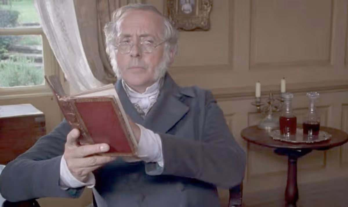 A man in glasses reads a book