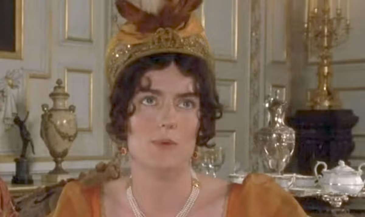 A woman in orange speaks