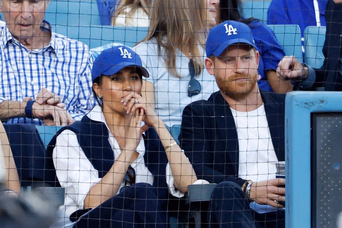 LOS ANGELES, CALIFORNIA - OCTOBER 28: Prince Harry, Duke of Sussex and Meghan, Duchess of Sussex look on from the stands during game four of the 2025 World Series between the Toronto Blue Jays and the Los Angeles Dodgers at Dodger Stadium on October 28, 2025 in Los Angeles, California. (Photo by Ronald Martinez/Getty Images)