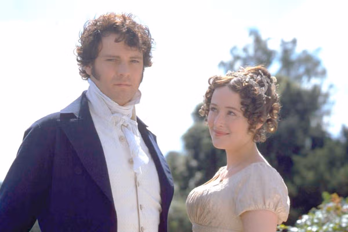 A woman looks up and smiles at a man