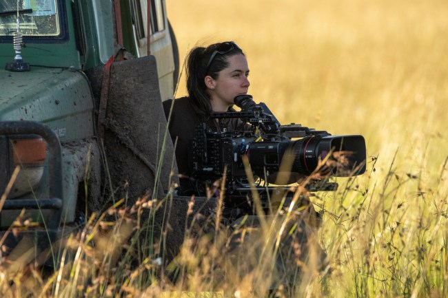 Cinematographer Tania Escobar looks out into the distance at Summer's pride, ready to begin filming as soon as the action starts to unfold. (National Geographic/Joe Treddenick)