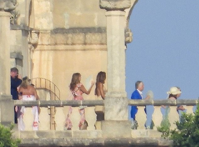 One guest can be seen with a fan as she walked to the celebration