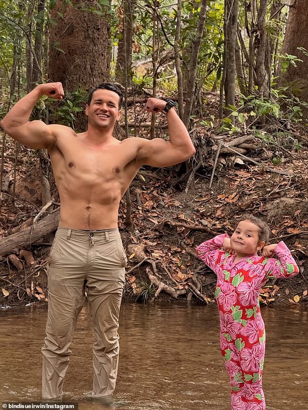 On Saturday, the celebrity conservationist, 28, shared a photo on social media showing her American-born husband, 29, going shirtless as he flexed his muscles alongside their five-year-old daughter, Grace