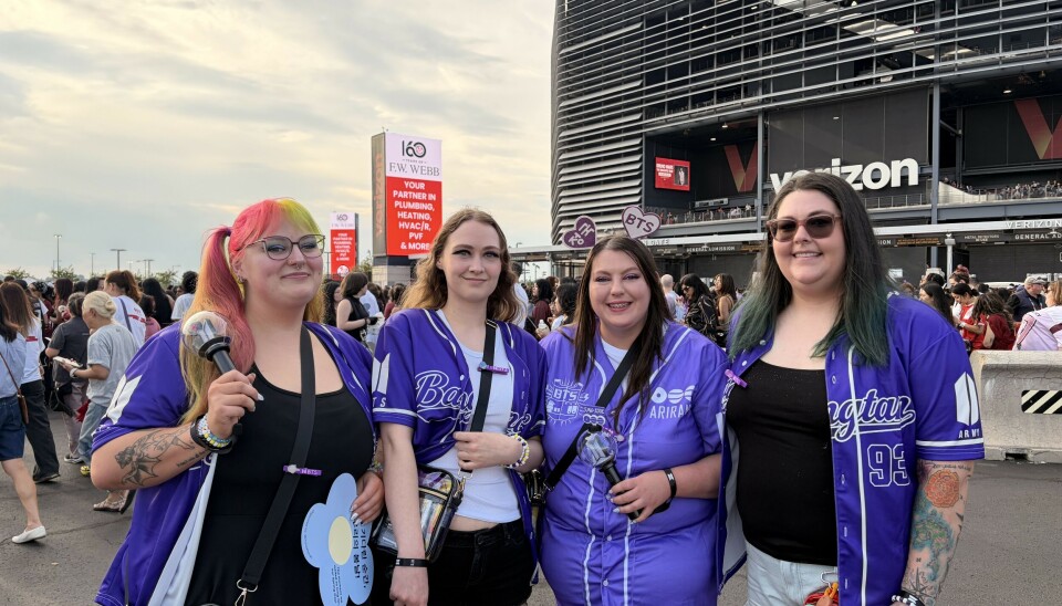 BTS fans pose for a photograph in front of MetLife Stadium in New Jersey, New York, on Aug.1.