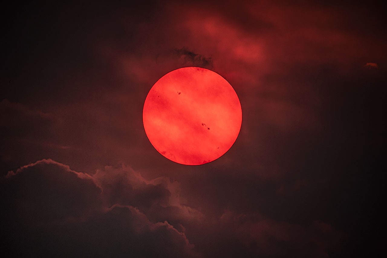 APOD: 2026 July 30 - Red Sun trough Wildfire Smoke