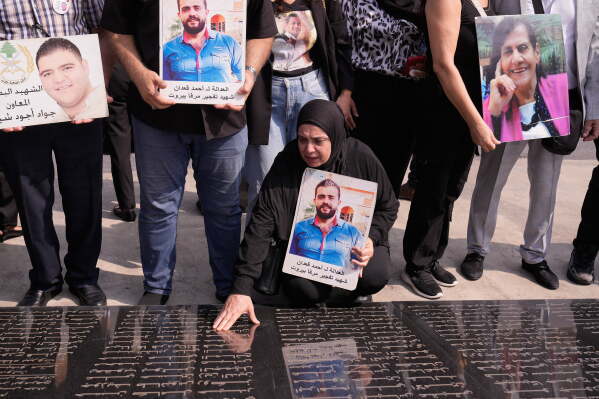 A relative of a victim of the deadly 2020 Beirut port explosion, cries at a memorial during a gathering marking the sixth anniversary of the massive blast at the site of the explosion in Beirut's port, Lebanon, Tuesday, Aug. 4, 2026. (AP Photo/Hussein Malla)
