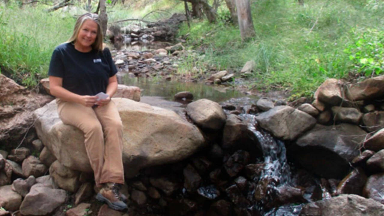 USGS scientist Laura Norman at a check dam built more than 30 years ago at El Coronado Ranch. Image Credits: Gerry Norman/USGS Image