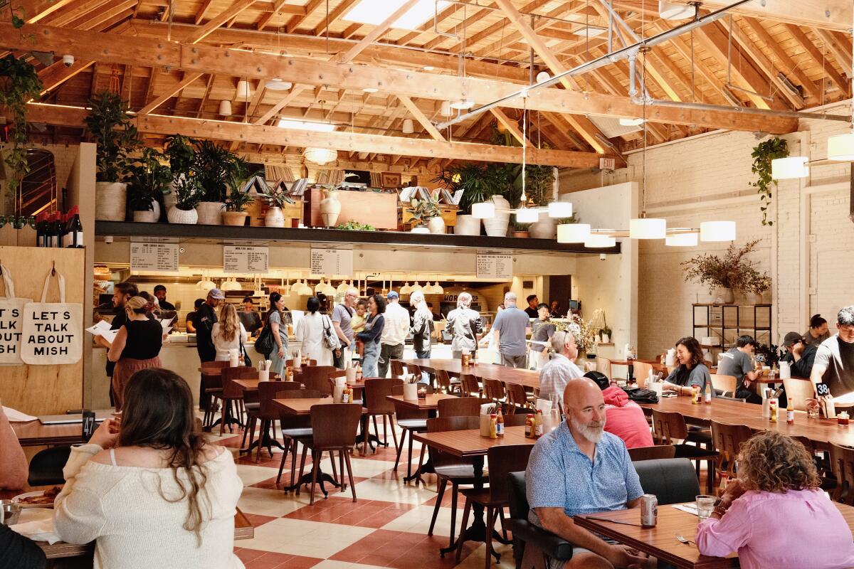 Guests in the busy dining room of modern Jewish deli Mish Delicatessen.