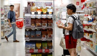 A woman looks at product prices at a department store in Taichung, Taiwan, on July 31. Yonhap