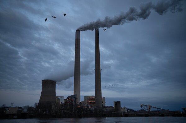 The coal-fired Mountaineer Power Plant, near New Haven, W.Va., operates across the Ohio River from the Lock 24 RV Park and Campground in Racine, Ohio, March 13, 2026. (AP Photo/Carolyn Kaster, File)