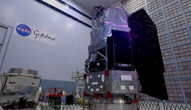 The boxy structure of the Nancy Grace Roman Space Telescope stands in a high-ceiling bay in a NASA facility.