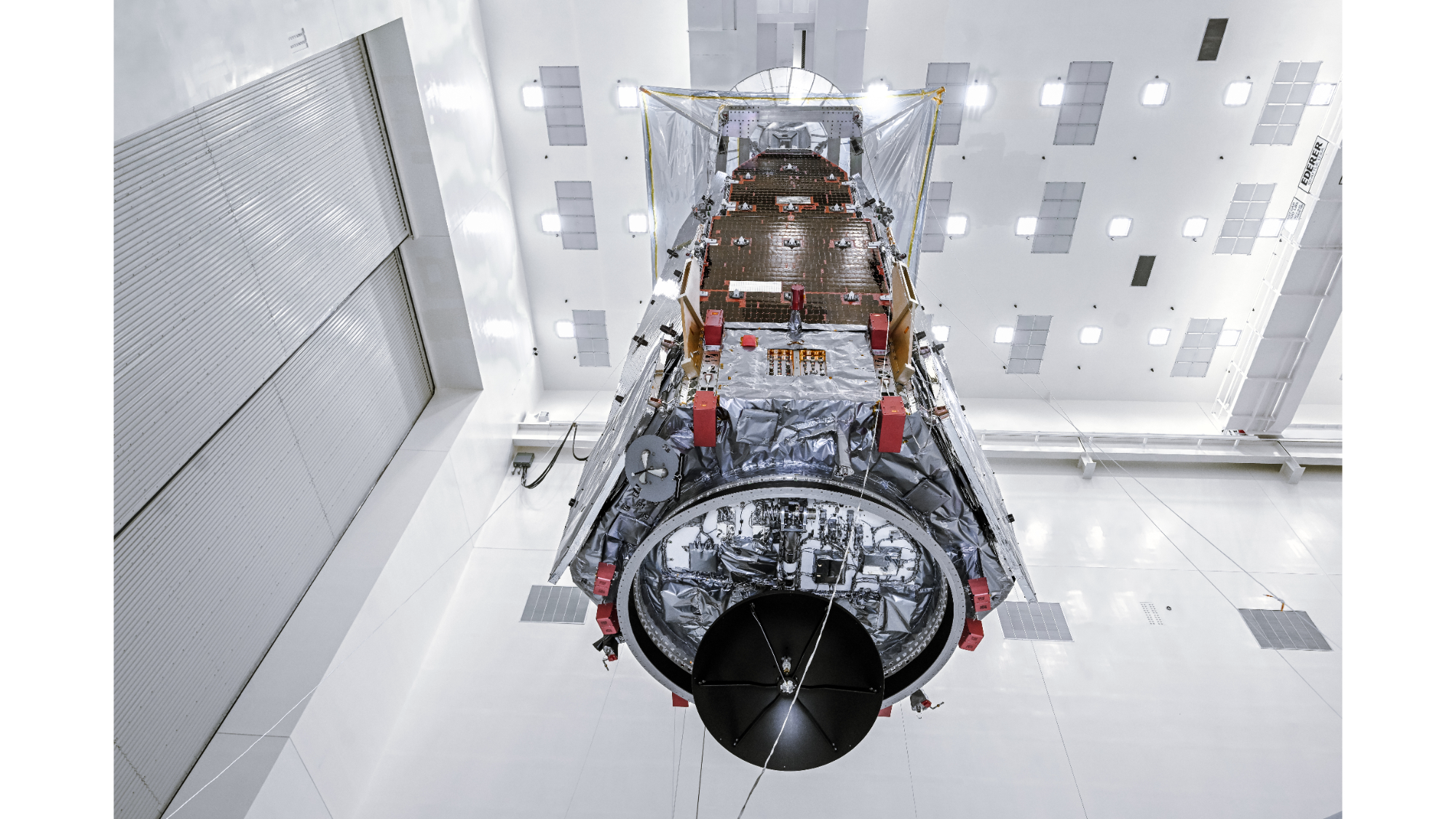 The Roman Space Telescope hangs in the clean room.