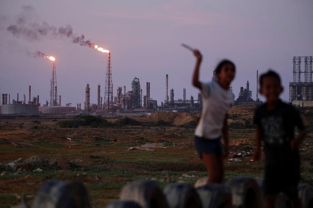 Children play near part of the Paraguana Refining Center in Venezuela in May 2026.