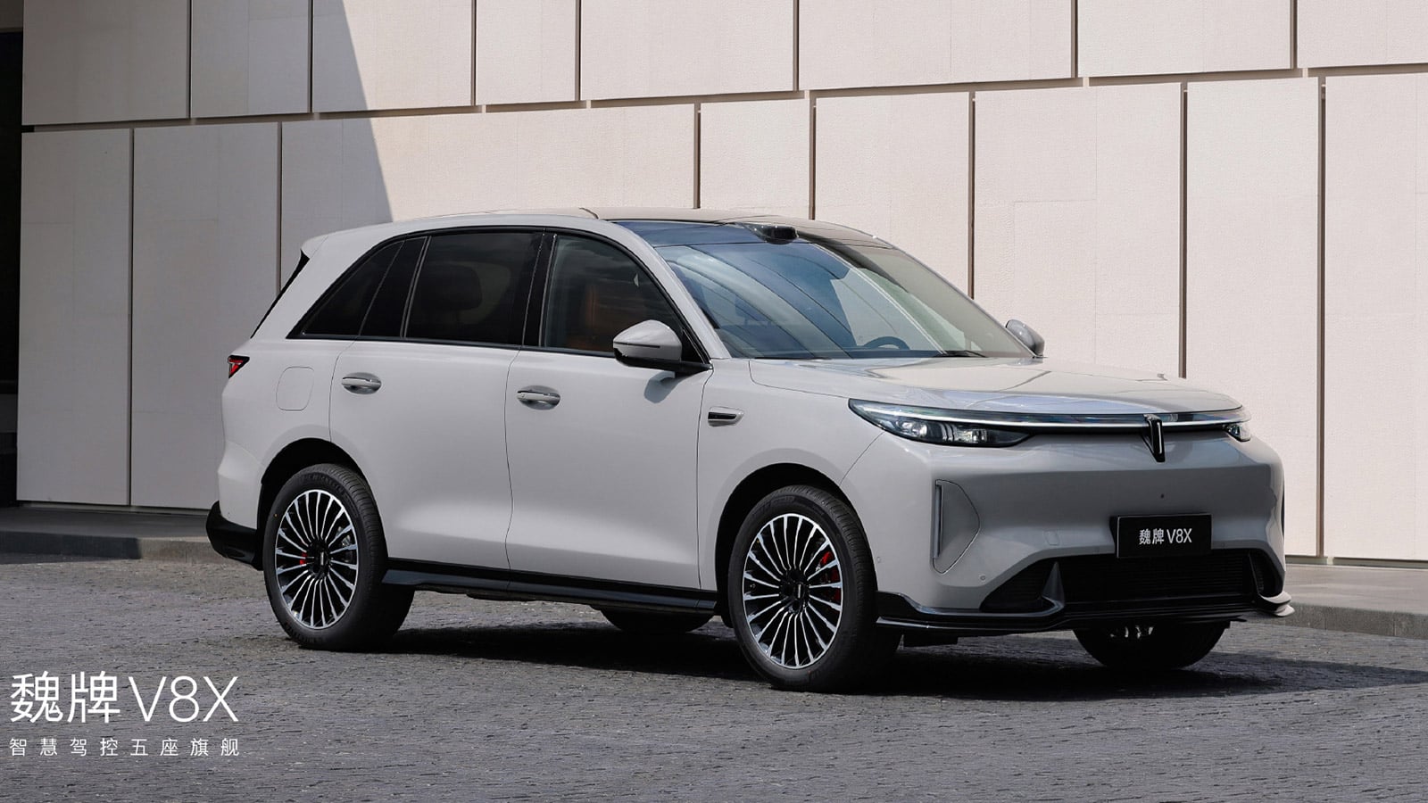 White Wey V8X SUV shown in a front three-quarter view outside a modern building.