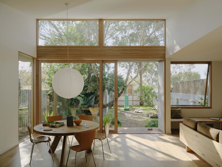 The compact kitchen/dining/living room is cleverly zoned using inbuilt joinery and varied views and volumes.
