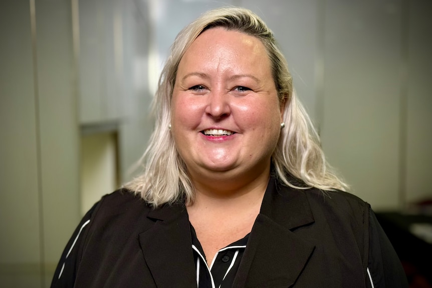 Woman with blonde hair smiles at camera