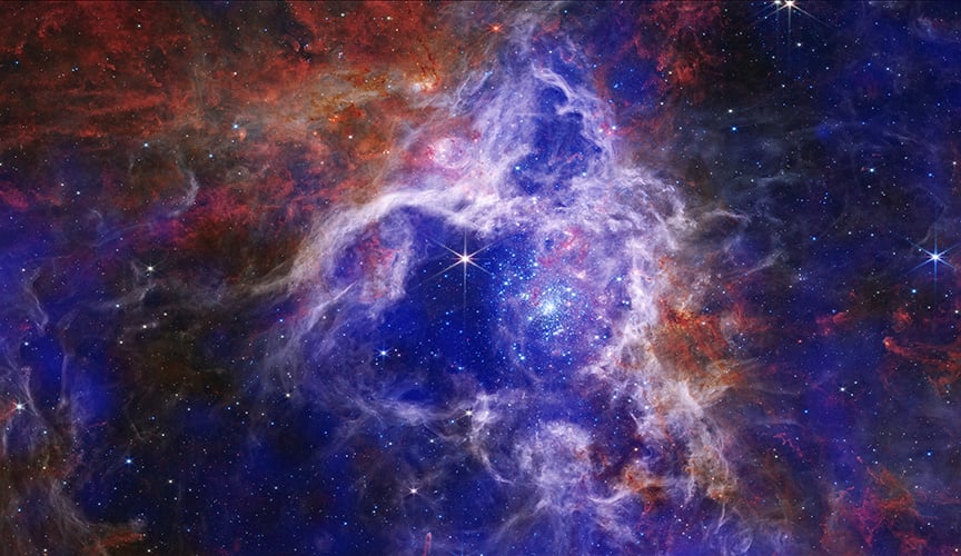 An earlier view of 30 Doradus combining Chandra's X-ray data with infrared from Webb — the deep, diffuse X-ray glow visible here is the very signal researchers found was fainter than their models predicted (Credit : X-ray: NASA/CXC; Infrared: NASA/ESA/CSA/STScI)
